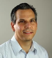 Samuel J. Kerstein headshot on brown background